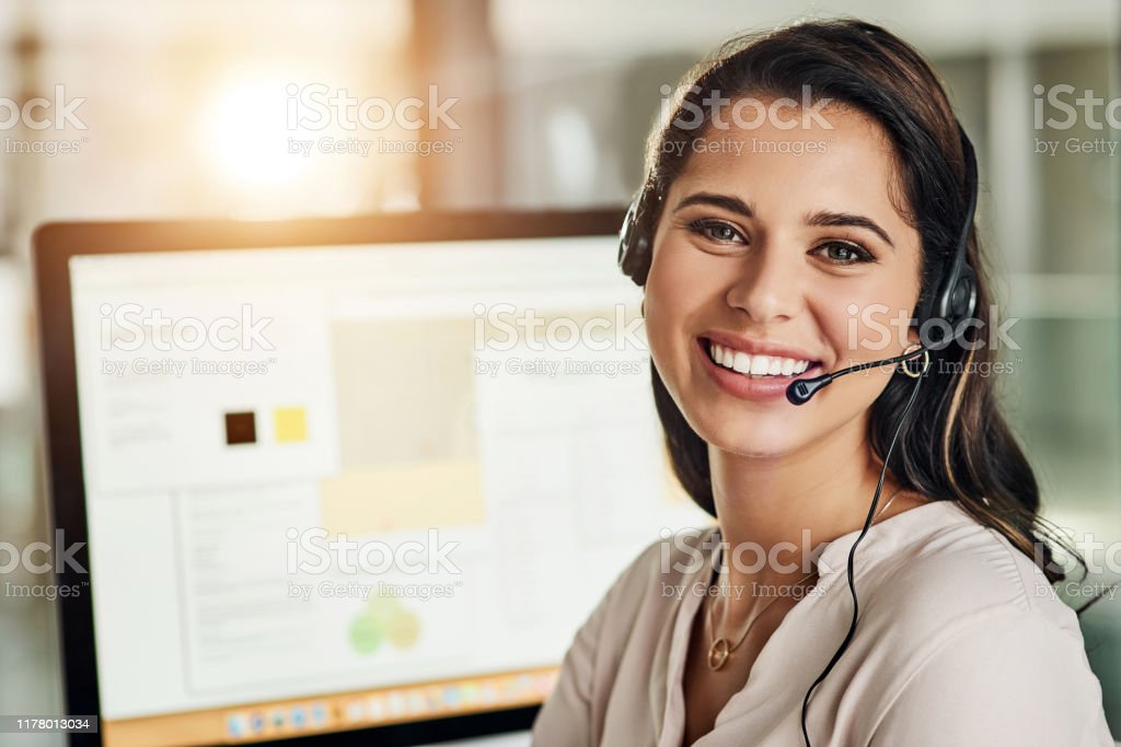 Cropped shot of an attractive young businesswoman wearing a headset and sitting alone in her office
